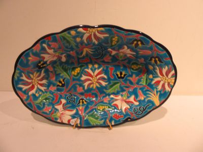 a blue bowl with a floral design on it on a table