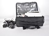 a black bag with a laptop in it sitting on the floor