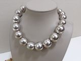 silver pearl necklace and bracelet set on display in a display case