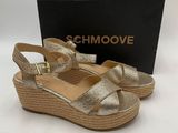 a pair of gold sandals with a box on the side