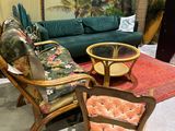 a living room with a couch, chair, table, and surfboard