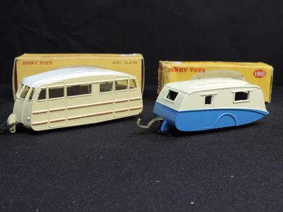 three toy vehicles are sitting next to each other on a black surface