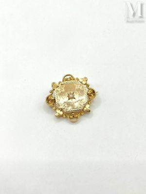 a close up of a gold ring on a white surface