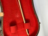 a red case with a wooden stick inside of it