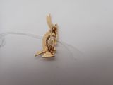 a gold bird that is sitting on top of a white table
