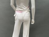 female mannequin wearing a white outfit with pink trimmings