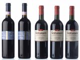 four bottles of red wine are lined up in a row
