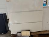 a picture of a white chest of drawers with a certificate on it