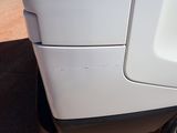 a close up of a white truck with a hole in the side
