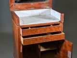 a small wooden cabinet with a mirror on top of it