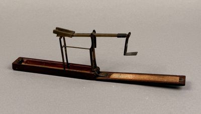 a miniature model of a plane on a wooden stand