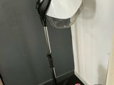 a lamp that is sitting on a tripod next to a book