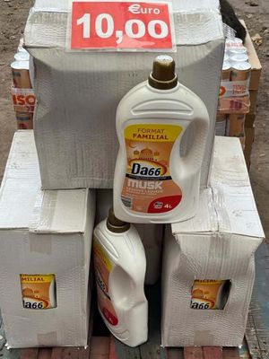 a stack of boxes with a bottle of detere on top of it