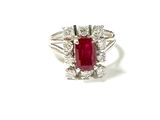 an image of a ring with a red stone surrounded by white diamonds