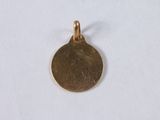 a close up of a gold coin on a white surface