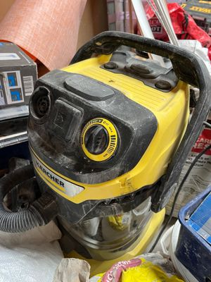 a yellow and black blower sitting on top of a pile of trash
