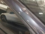 a car that is parked in a garage with its door open