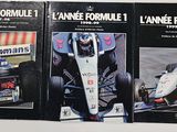three books on a white table with a picture of a racing car