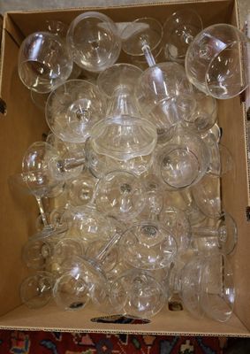 a box full of empty wine glasses sitting on the floor