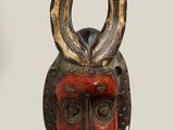 an image of a wooden mask with horns on it ' s head
