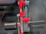 a bench with a red handle on it in a gym