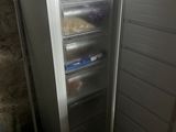 an open refrigerator that is sitting in the corner of a room