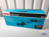 the box of a sander is sitting on a white table