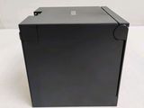 a close up of a black box on a white surface