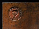 a close up of a metal object with a medallion on it