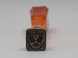 a close up of a metal stamp with an eagle on it