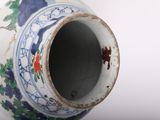a white vase with a blue and red design on it