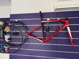 a bike hanging on the wall next to a bike rack