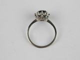 a close up of a ring with a diamond on it