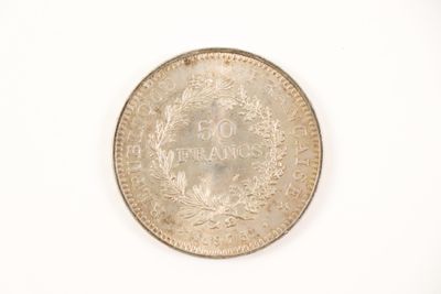a close up of a coin on a white surface with a white background