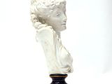 a statue of a woman that is sitting on a table