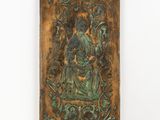 an old metal plaque with an image of a woman holding a child