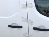 a white van that has been vandalized with stickers on it
