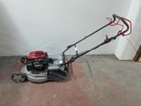 a lawn mower that is sitting on the ground