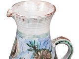 a blue and white vase with a handle on a white background