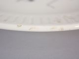 a close up of a white plate with a clock on it