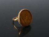 an image of a gold ring with a penny on it