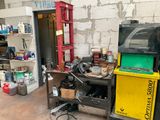 an image of a garage with a lot of stuff on the floor