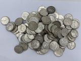 pile of silver coins sitting on top of a white surface