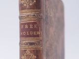 an old book sitting on top of a white table
