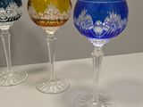 three wine glasses sitting on a table next to each other