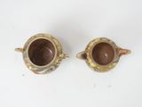 pair of antique japanese pottery teapots on white background