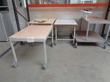 two tables that are on wheels in a room