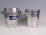 pair of silver ice buckets with handles on a white surface