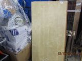 a wooden cabinet in the middle of a pile of boxes