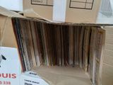 a cardboard box with a bunch of records in it